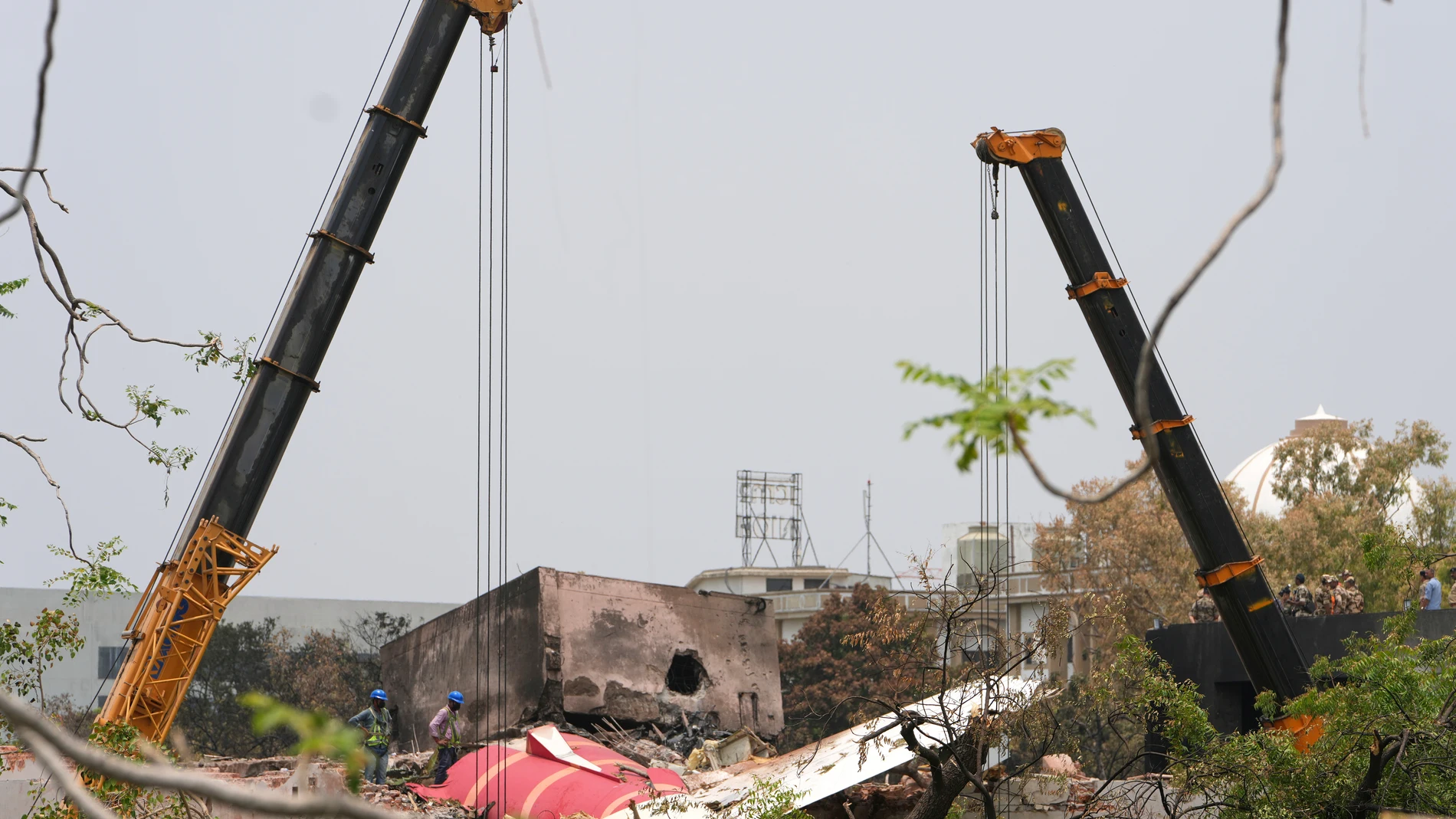 A crew works at the site of Thursday's Air India plane crash in Ahmedabad, India, Saturday, June 14, 2025. (AP Photo/Ajit Solanki)