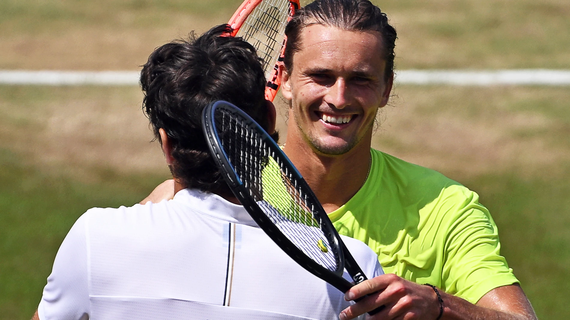 Taylor Fritz of the USA is congratulated by Germany's Alexander Zverev, right, after winning the men's singles final tennis match of the Stuttgart Open, Stuttgart, Germany, Sunday, June 15, 2025. (Marijan Murat/dpa via AP)