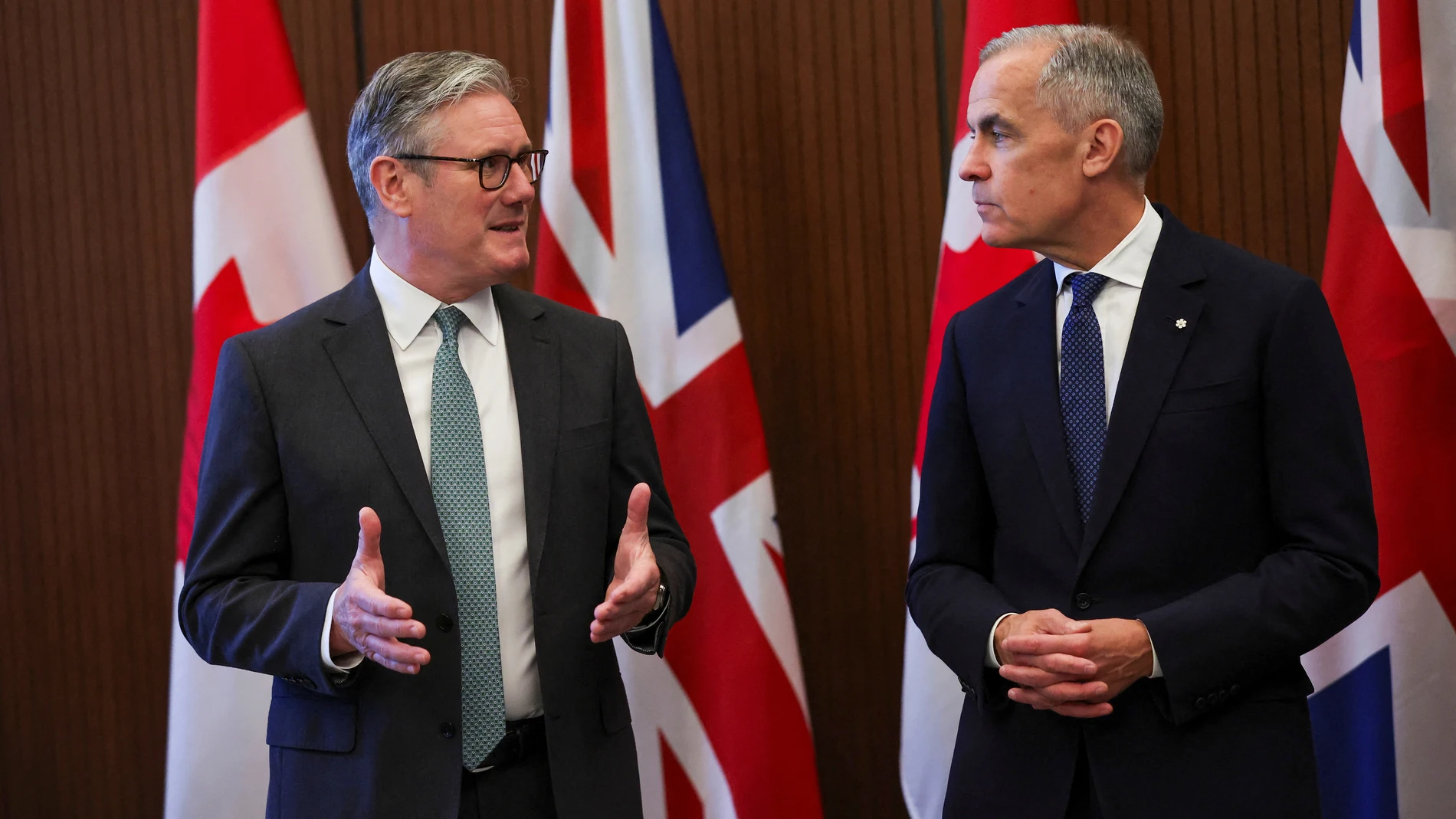 Canada's Prime Minister Mark Carney, right, meets with Britain's Prime Minister Keir Starmer before the start of the G7 summit, at Parliament Hill in Ottawa, Ontario, Sunday June 15, 2025. (Suzanne Plunkett/Pool Photo via AP)