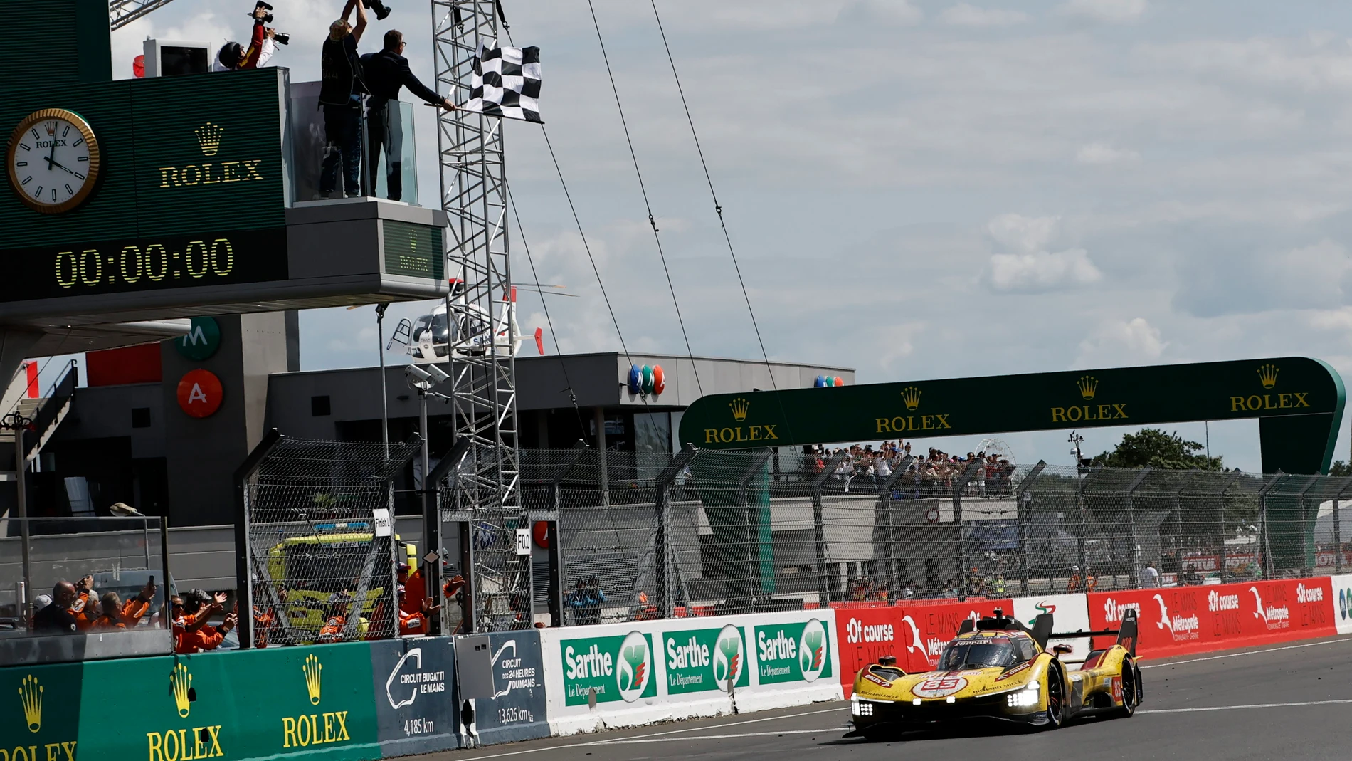 Robert Kubica of Poland in his AF Corse car a Ferrari 499P crosses the finish line to win the 24-hour Le Mans endurance race, Sunday June 15, 2025 in Le Mans, western France. (AP Photo/Jeremias Gonzalez)