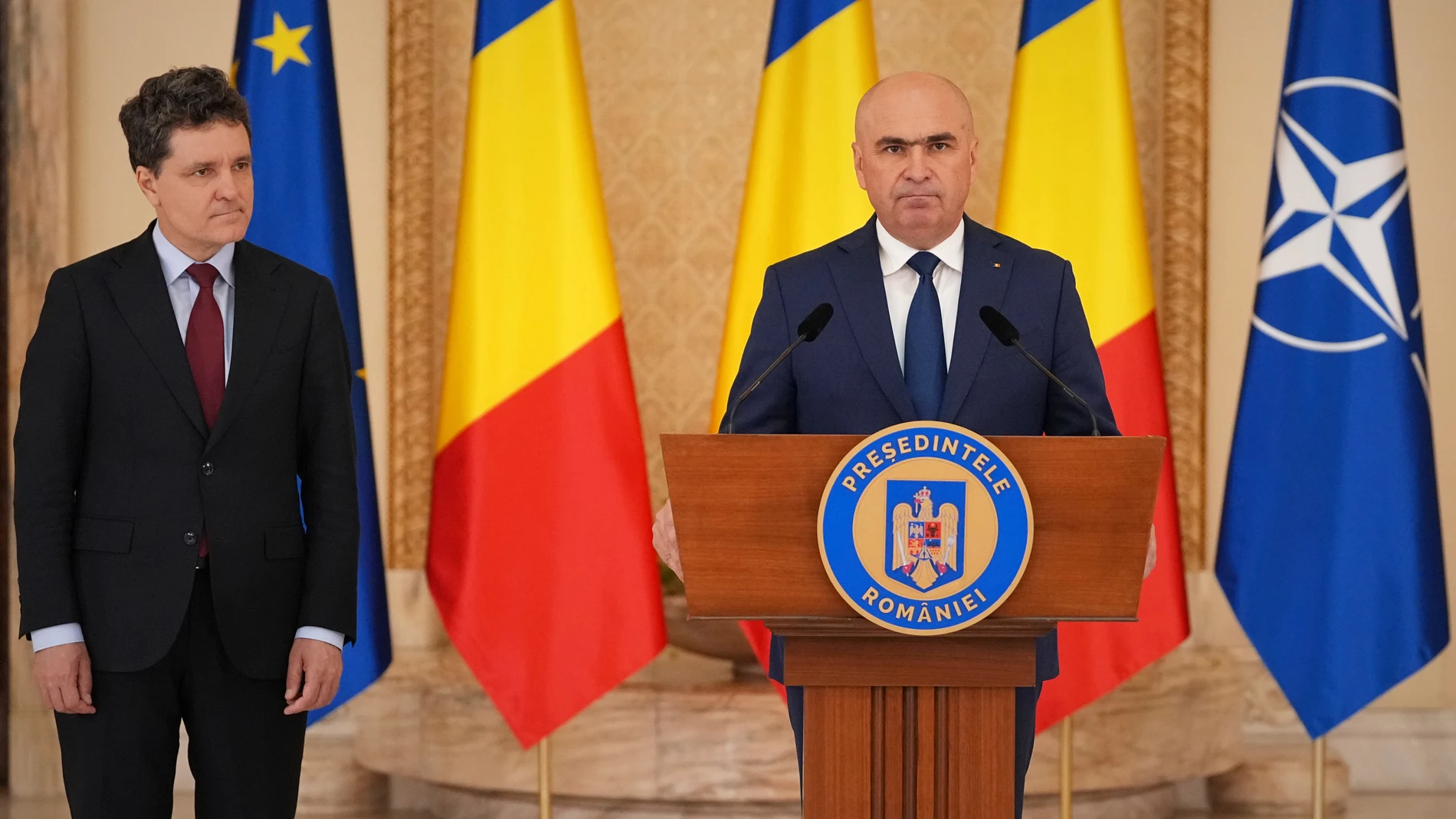 Ilie Bolojan, the President of the country's senate, speaks after Romanian President Nicusor Dan, left, nominated him as the new Prime Minister, at the Cotroceni Presidential Palace in Bucharest, Romania, Friday, June 20, 2025. (AP Photo/Andreea Alexandru)