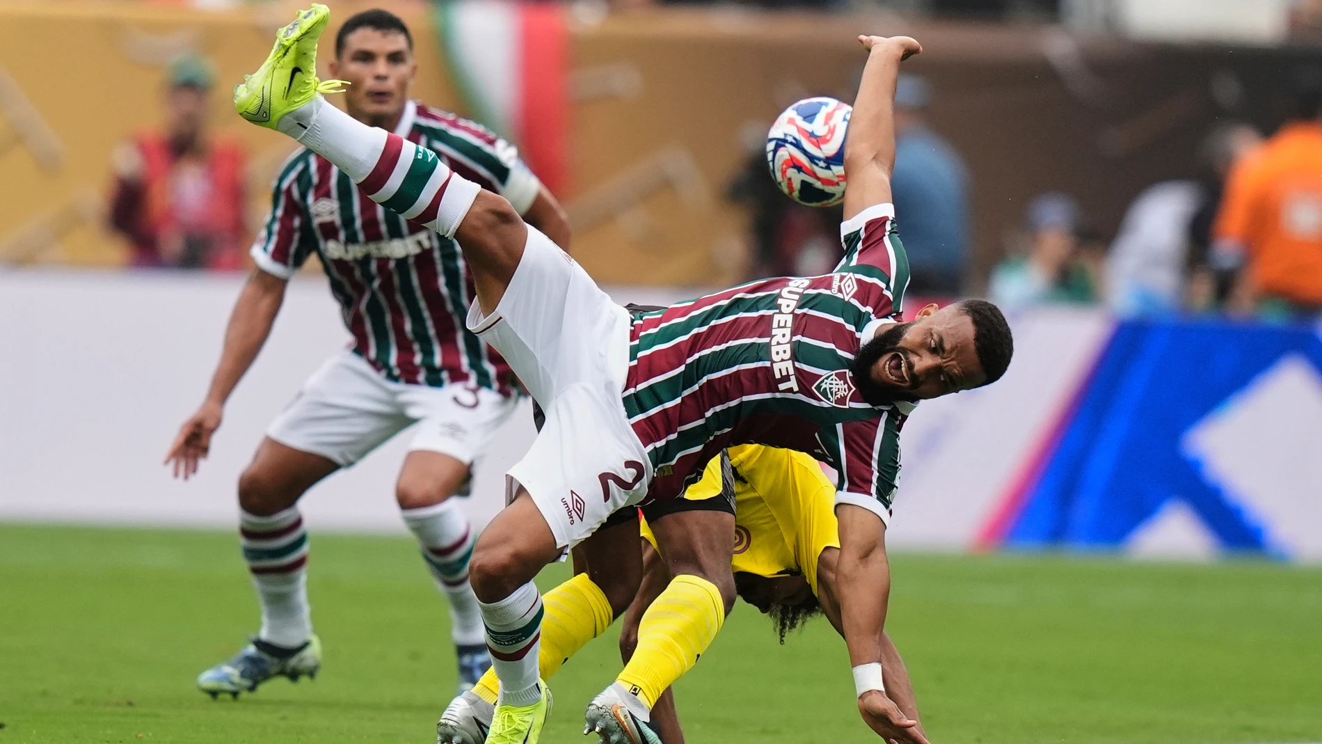Fluminense's Samuel Xavier (2), and Borussia Dortmund's Karim Adeyemi collide as they battle for the ball during the Club World Cup group F soccer match between Fluminense and Borussia Dortmund in East Rutherford, N.J., Tuesday, June 17, 2025. (AP Photo/Frank Franklin II)