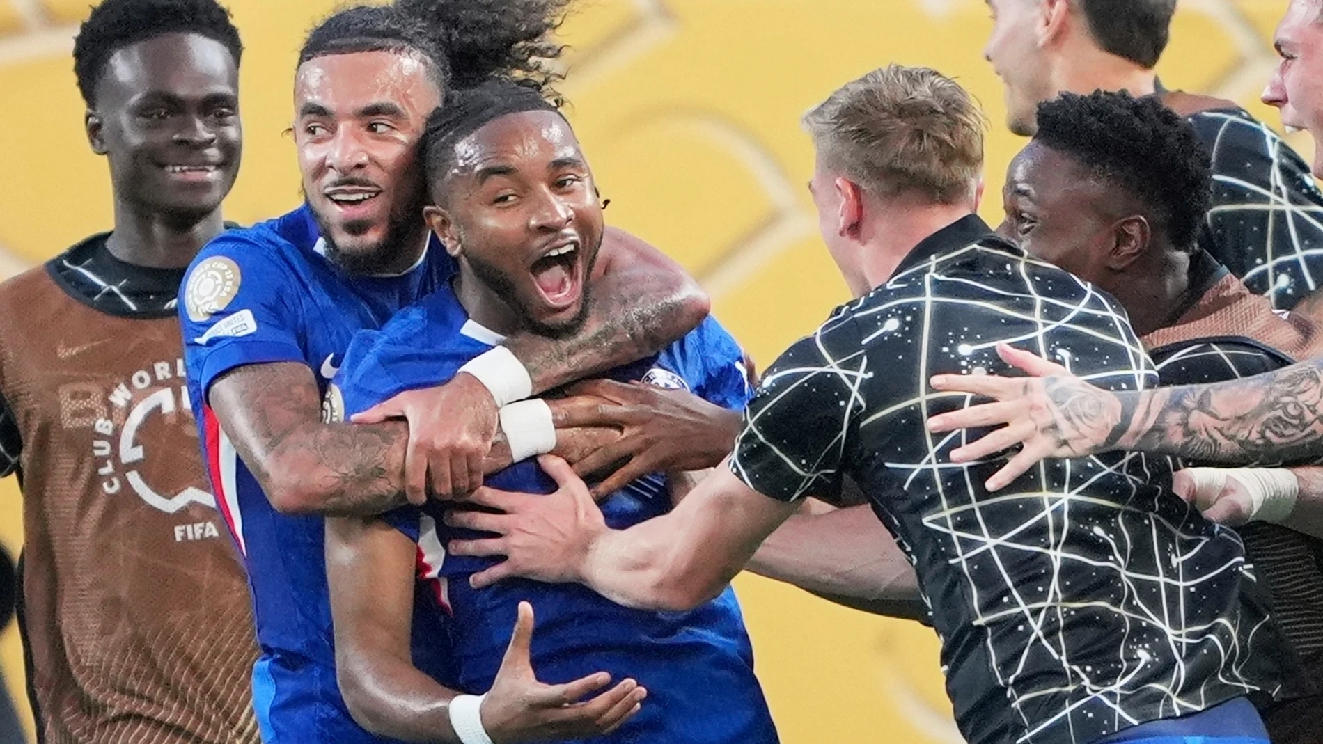 Chelsea's Christopher Nkunku is congratulated after scoring his teams second goal during the Club World Cup round of 16 soccer match between Benfica and Chelsea in Charlotte, N.C., Saturday, June 28, 2025. (AP Photo/Chris Carlson)
