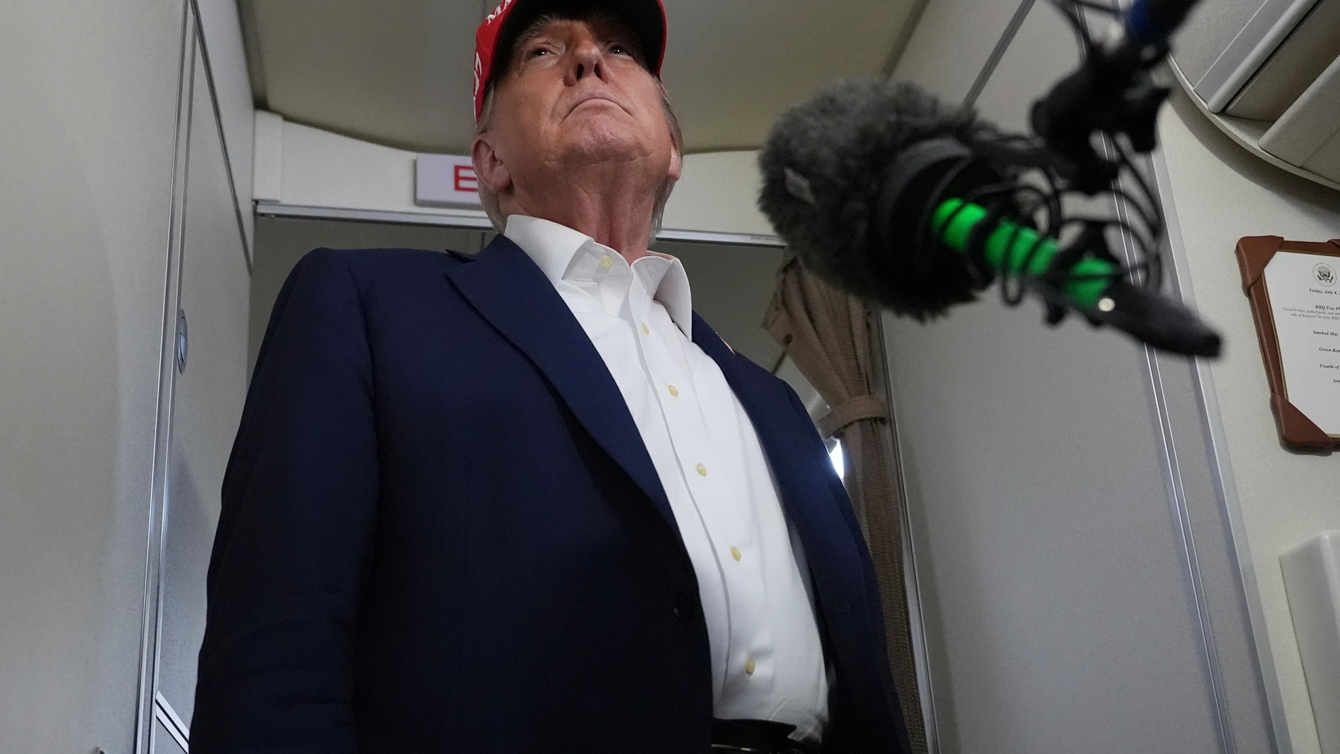 President Donald Trump speaks to reporters on board Air Force One, en route from Joint Base Andrews, Md., to Morristown Municipal Airport in Morristown, N.J., Friday, July 4, 2025. (AP Photo/Jacquelyn Martin)