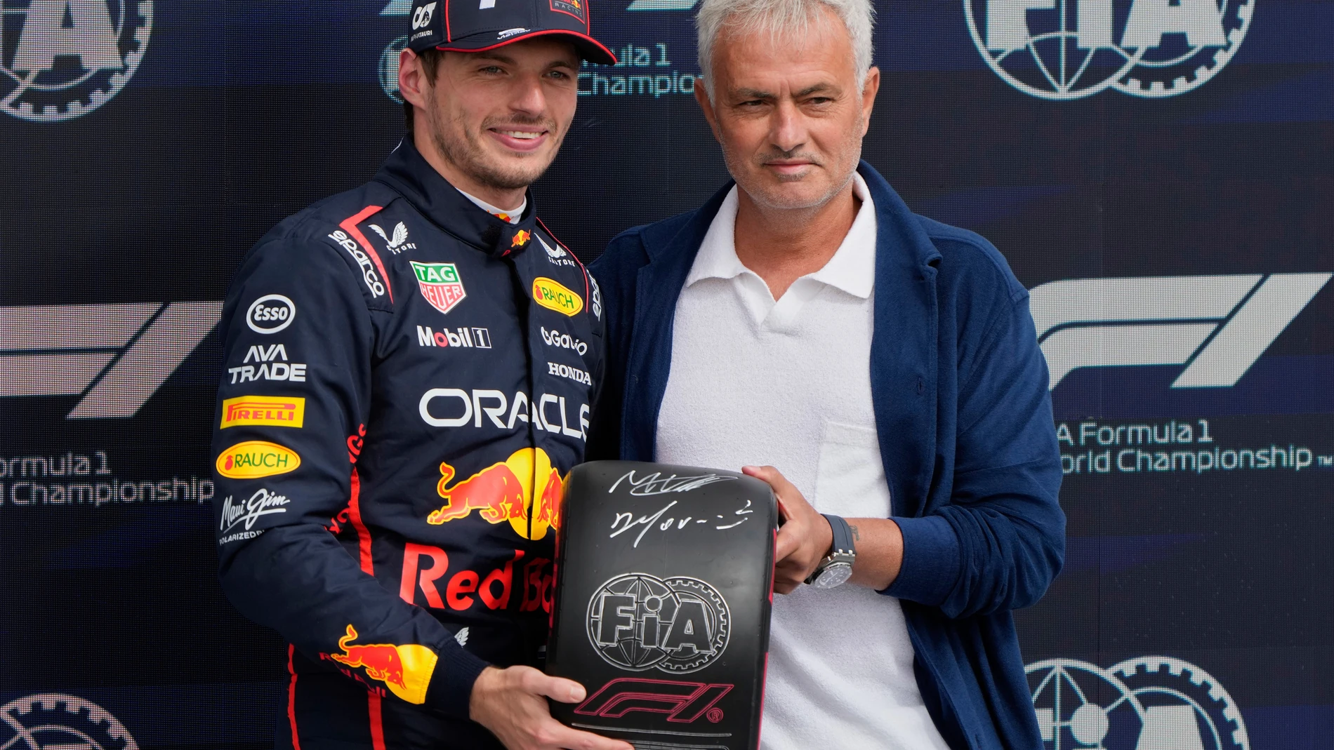 Red Bull driver Max Verstappen of the Netherlands and a soccer coach Jose Mourinho pose after the qualifying for the British Formula One Grand Prix in Silverstone, England, Saturday, July 5, 2025. (AP Photo/Darko Bandic)