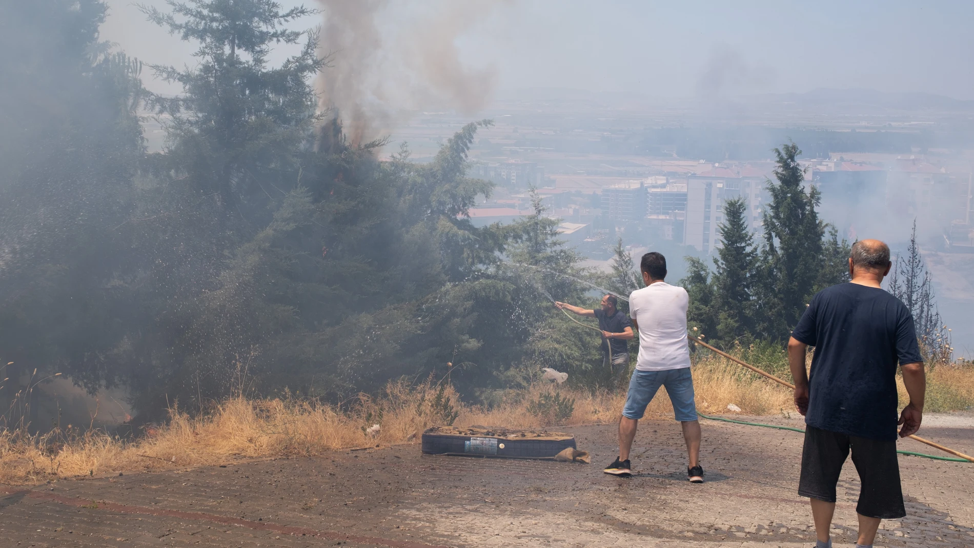 July 2, 2025, Izmir, Turkey: People seen trying to extinguish a fire in Menemen district of Izmir. In Izmir, the western city of Turkey, forest fires have been out of control for days as temperatures and winds rise. Thousands of hectares of land were burned in various parts of the city. Many people have been evacuated from their homes and many animals died and injured in these fires. Europa Press/Contacto/Murat Kocabas 02/07/2025 ONLY FOR USE IN SPAIN