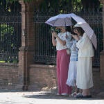 Varias mujeres se protegen del sol este domingo 
