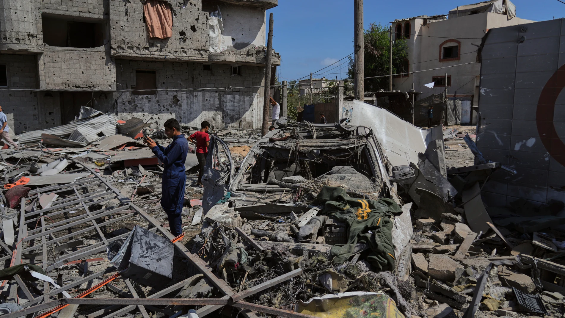 Palestinians inspect the wreckage of a gas station destroyed in an Israeli airstrike in Deir al-Balah, central Gaza Strip, Saturday, July 12, 2025. (AP Photo/Abdel Kareem Hana)