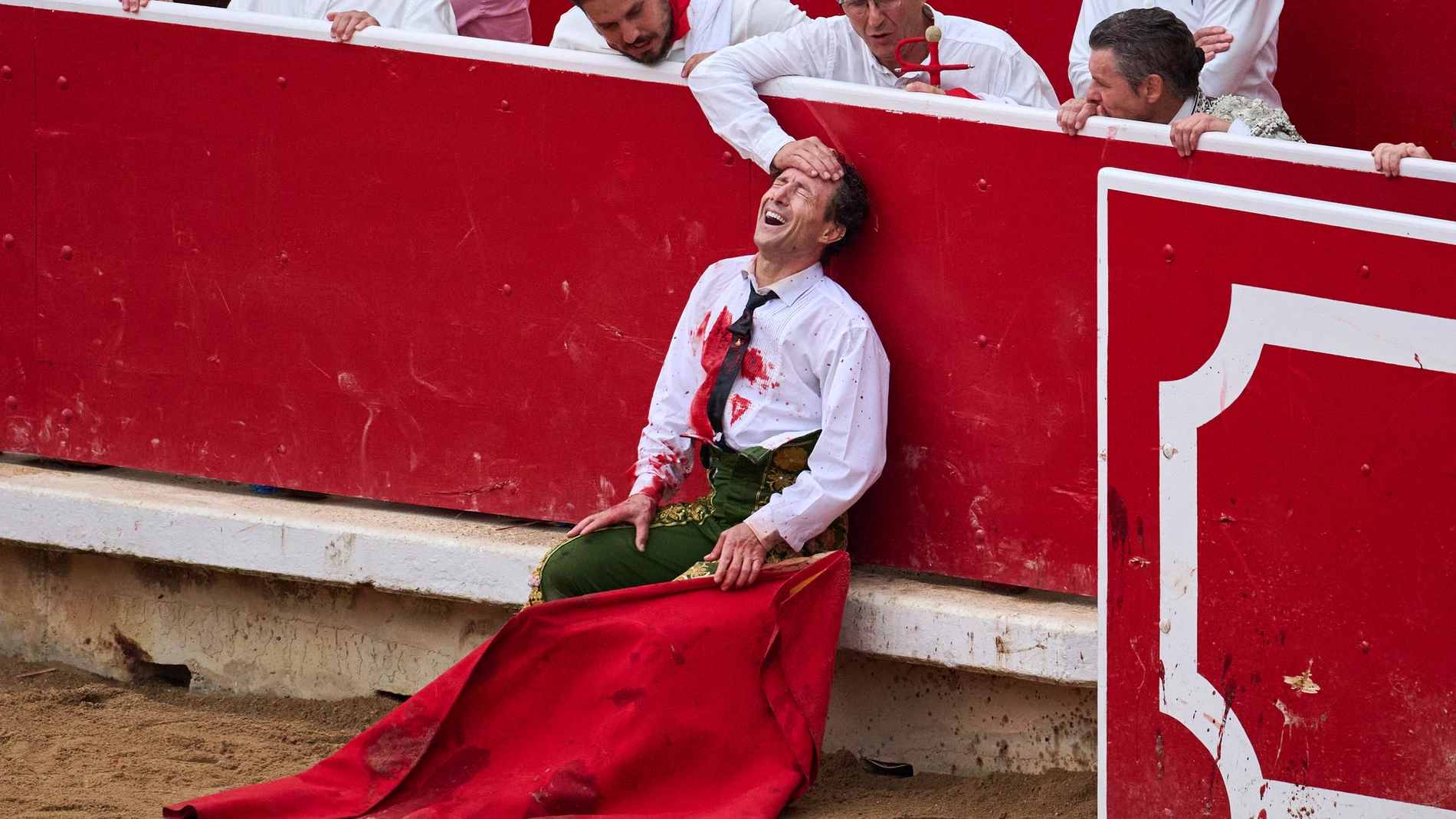 Spanish bullfighter Rafaelillo grimaces in pain after being gored by a bull during a bullfight at the San Fermín festival in Pamplona, northern Spain, Saturday, July 12, 2025. (AP Photo/Miguel Oses)