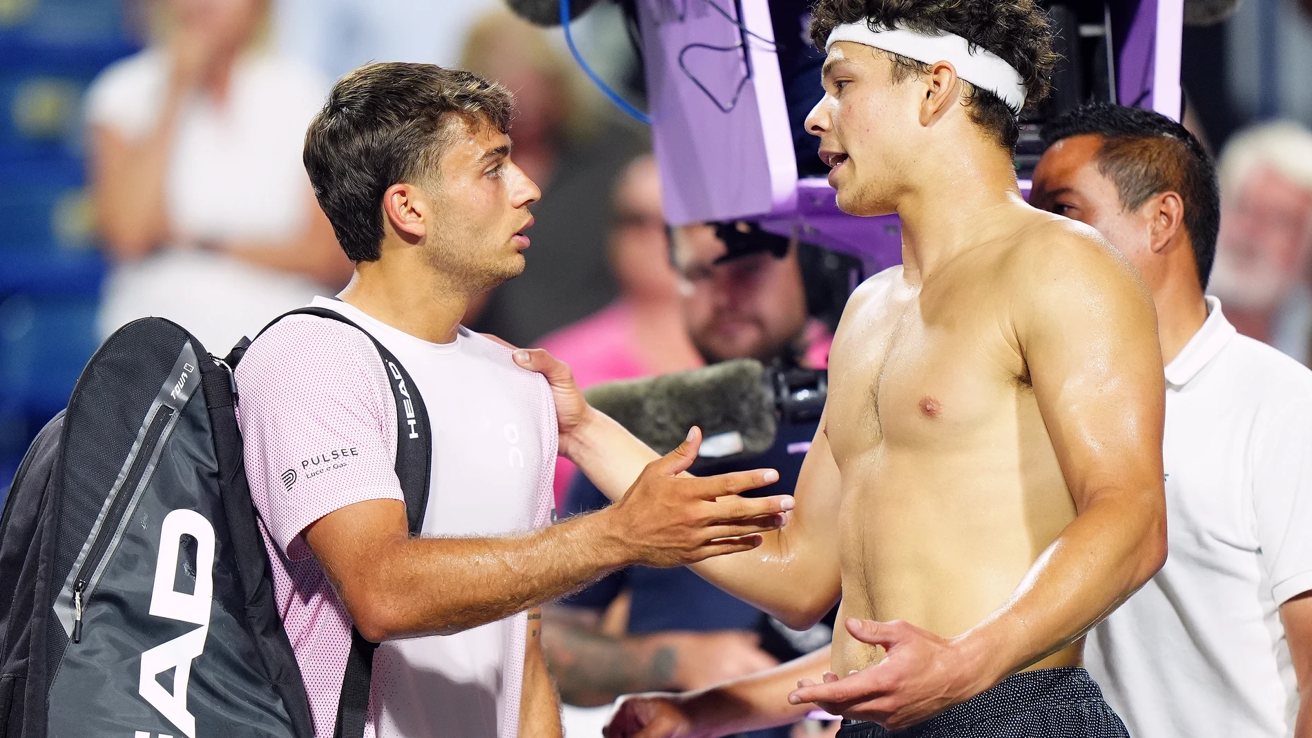 Ben Shelton, right, of the United States, has a discussion with his defeated opponent, Italy's Flavio Cobolli, left, following their match at the National Bank Open men's tennis tournament in Toronto, Sunday, Aug. 3, 2025. (Frank Gunn/The Canadian Press via AP)