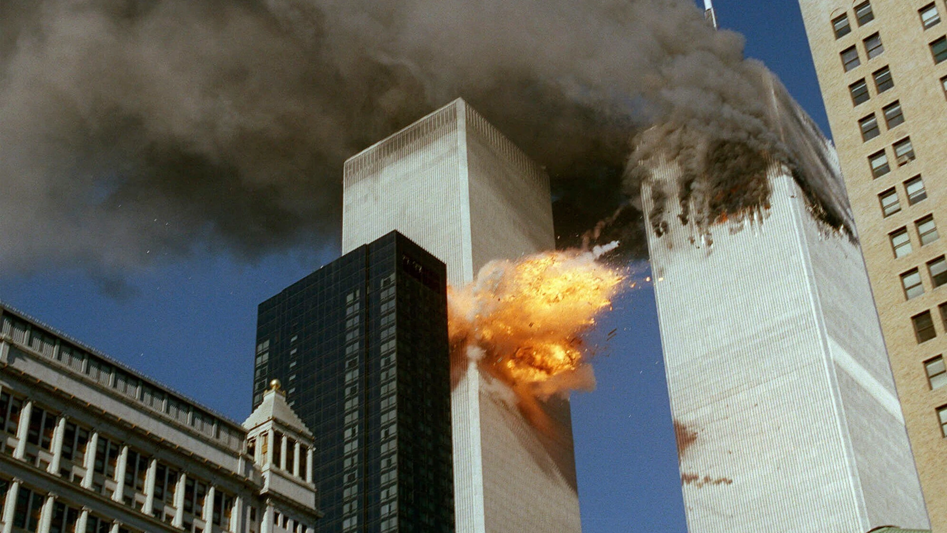 FILE - In this Sept. 11, 2001 file photo, United Airlines Flight 175 collides into the south tower of the World Trade Center in New York as smoke billows from the north tower. (AP Photo/Chao Soi Cheong, file)