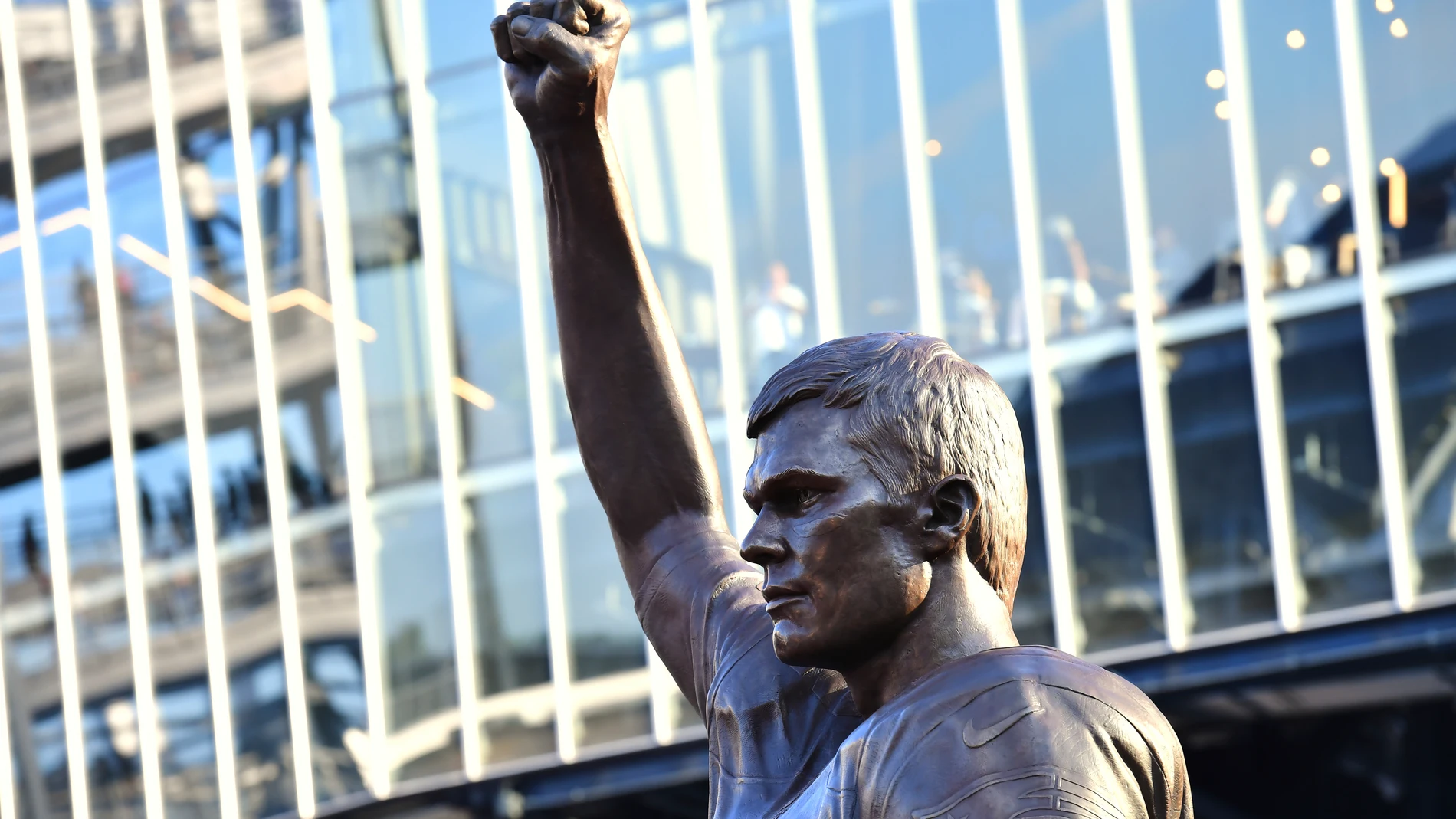 A bronze statue of former New England Patriots quarterback Tom Brady is unveiled in Patriot Place Plaza before an NFL preseason football game between the Washington Commanders and the New England Patriots Friday, Aug. 8, 2025, in Foxborough, Mass. (AP Photo/Steven Senne)