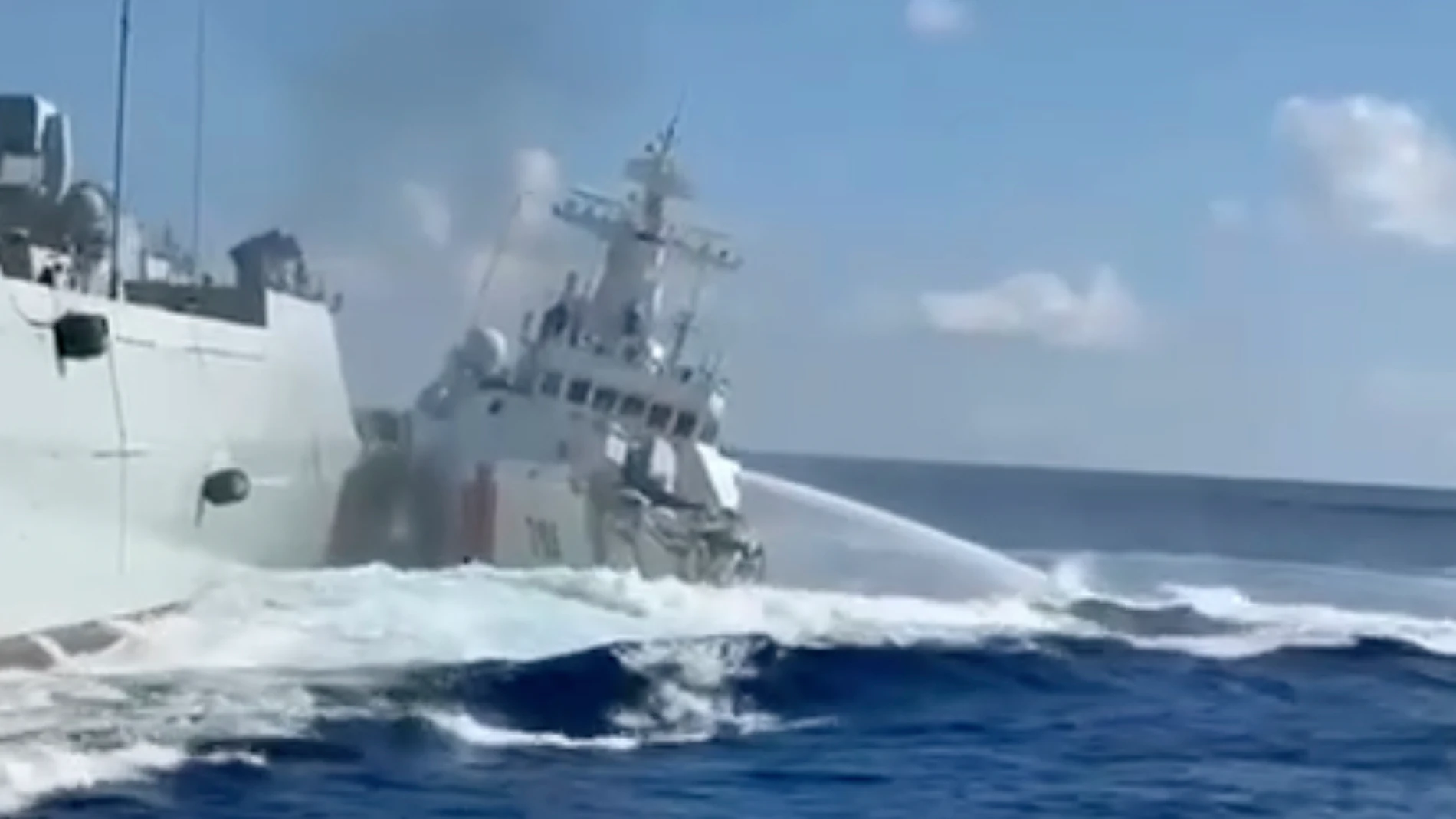 In this photo, taken from video and provided by the Philippine Coast Guard, a damaged Chinese Coast Guard ship, right, is seen beside a Chinese Navy vessel, left, after they accidentally collided while chasing a Philippine fisheries boat near Scarborough Shoal in the disputed South China Sea on Monday Aug. 11, 2025. (Philippine Coast Guard via AP)