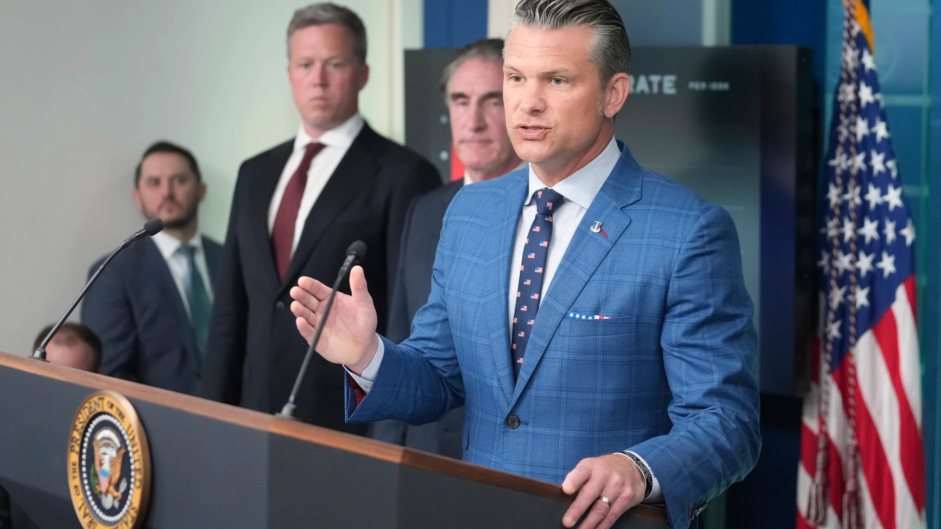 Defense Secretary Pete Hegseth, from right, speaks as Interior Secretary Doug Burgum and Army Secretary Dan Driscoll listen during a press briefing with President Donald Trump in the James Brady Press Briefing Room at the White House, Monday, Aug. 11, 2025, in Washington. (AP Photo/Mark Schiefelbein)