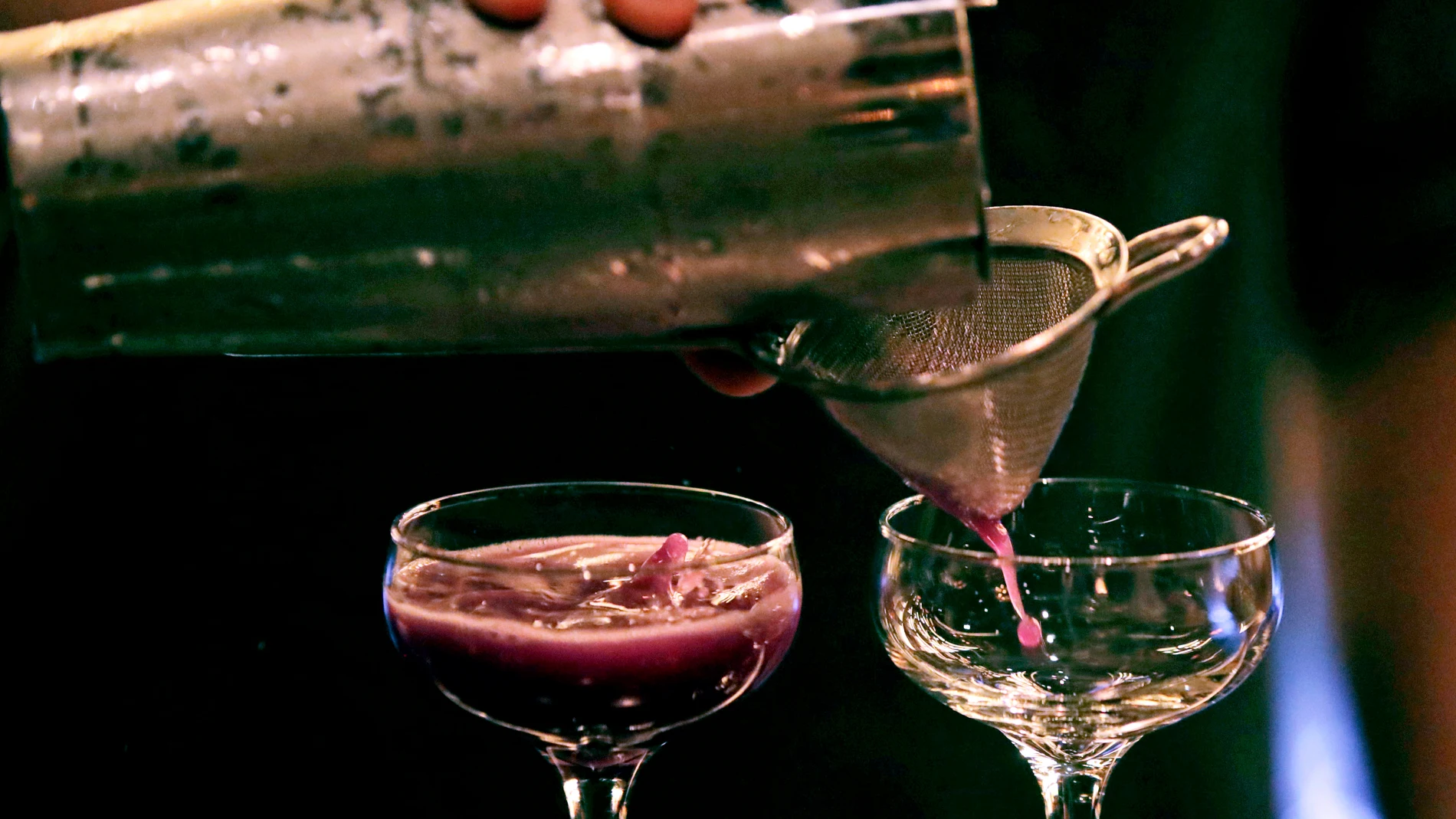 FILE - A bartender pours a cocktail in Dec. 10, 2019, in Boston. (AP Photo/Charles Krupa, File)