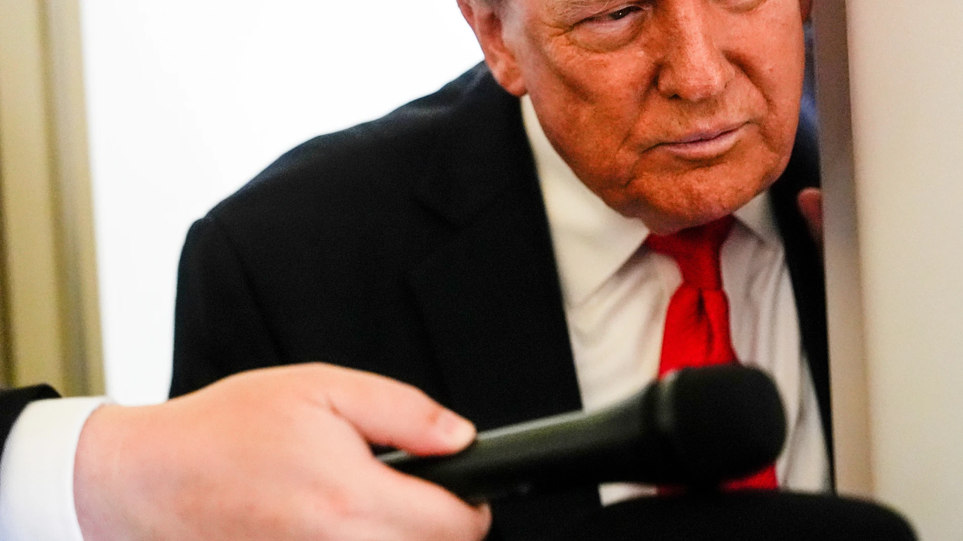 President Donald Trump speaks to reporters aboard Air Force One while en route to meet with Russia's President Vladimir Putin at Joint Base Elmendorf-Richardson, Alaska, Friday, Aug. 15, 2025. (AP Photo/Julia Demaree Nikhinson)
