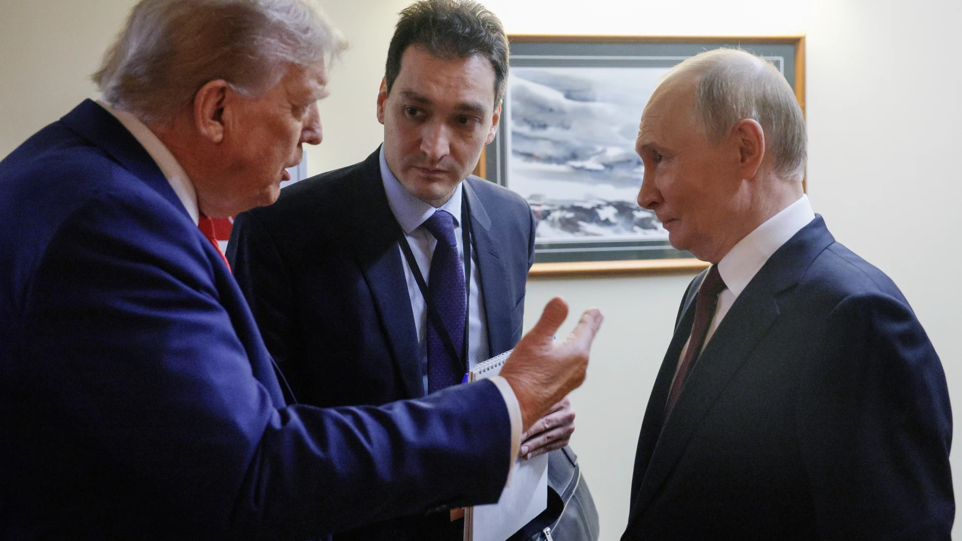 U.S. President Donald Trump, left, speaks to Russian President Vladimir Putin after their joint news conference on Friday, Aug. 15, 2025, at Joint Base Elmendorf-Richardson, Alaska. ((Gavriil Grigorov, Sputnik, Kremlin Pool Photo via AP)