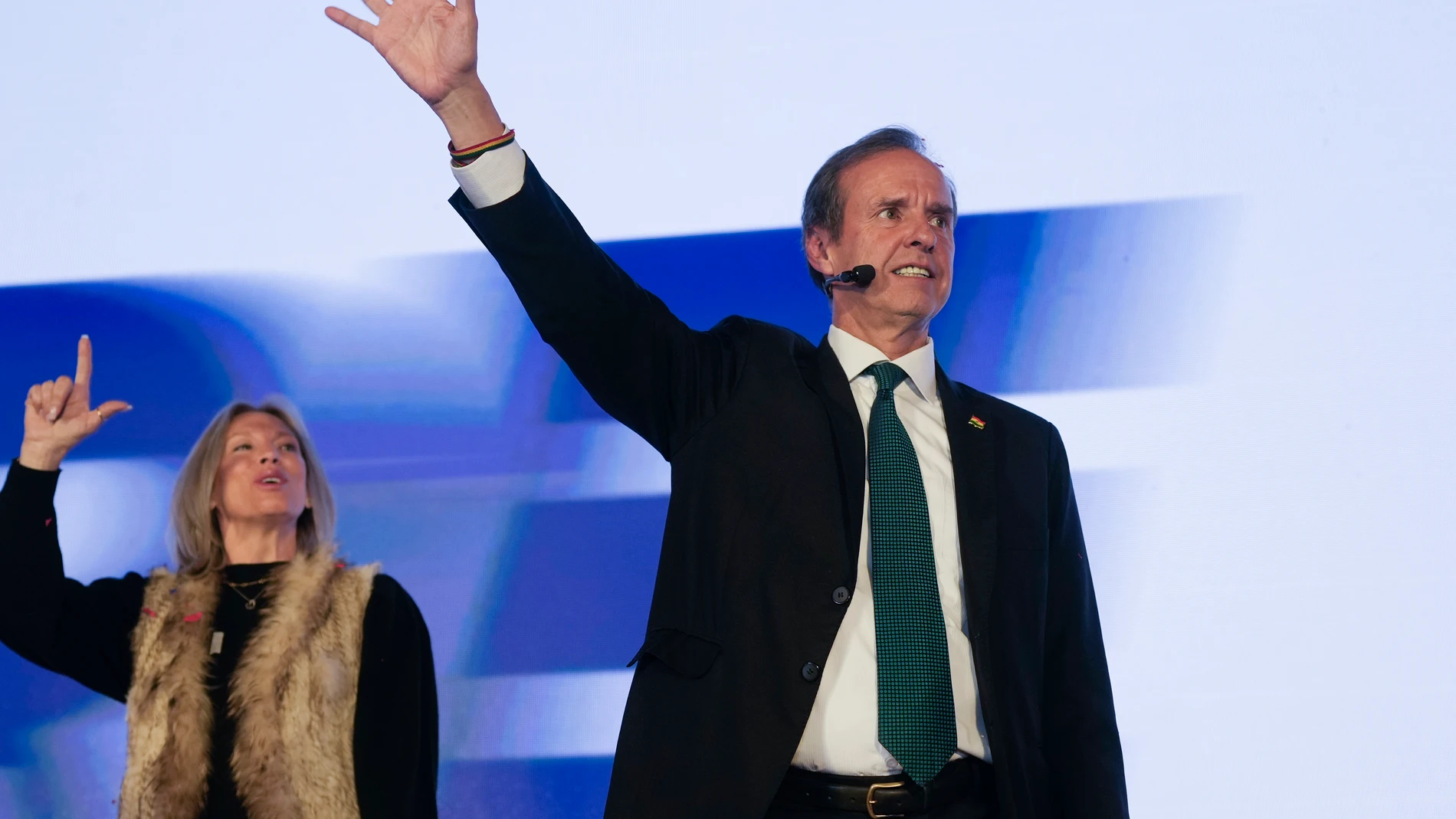 Presidential candidate Jorge "Tuto" Quiroga, right, and his wife, Milena Dobronic, addresses supporters after early results in the presidential election in La Paz, Bolivia, Sunday, Aug. 17, 2025. (AP Photo/Juan Karita)