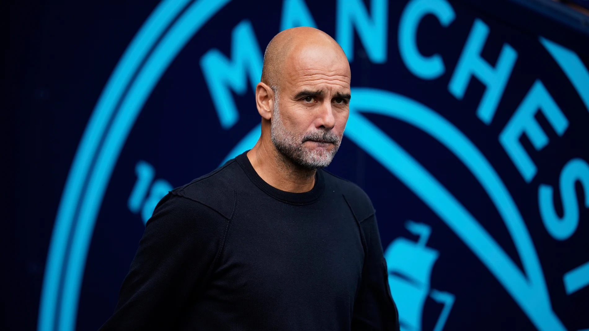 Manchester City's head coach Pep Guardiola stands before the Premier League soccer match between Manchester City and Tottenham in Manchester, England, Saturday, Aug. 23, 2025. (AP Photo/Dave Thompson)