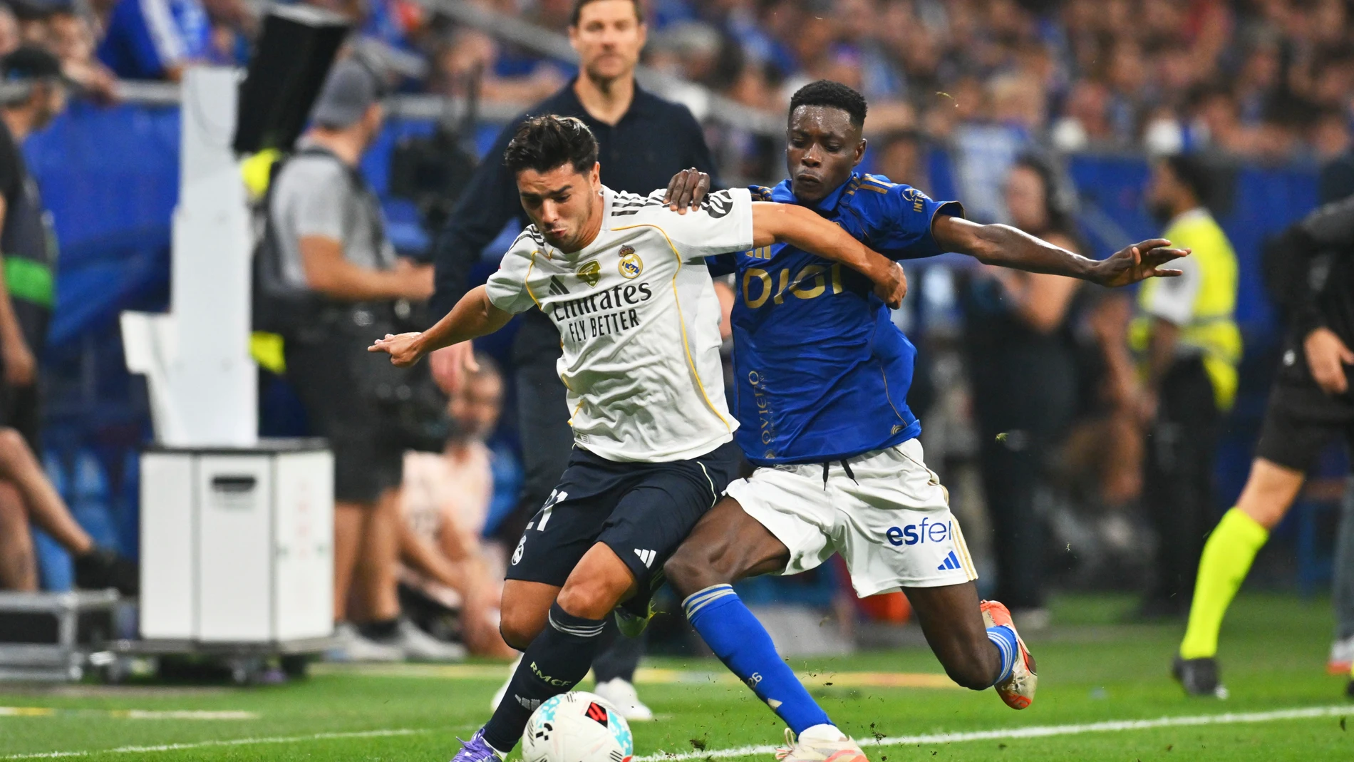 Real Madrid's Brahim Diaz, left, and Oviedo's Rahim Alhassane vie for the ball during a Spanish La Liga soccer match between Real Oviedo and Real Madrid at Carlos Tartiere stadium in Oviedo, Spain, Sunday, Aug. 24, 2025. (AP Photo/Miguel Oses)