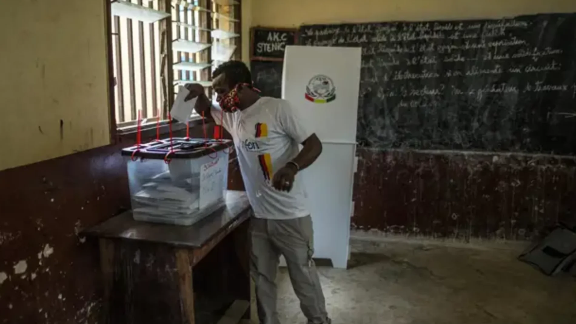 Un votante deposita su voto en un colegio electoral en Conakry
